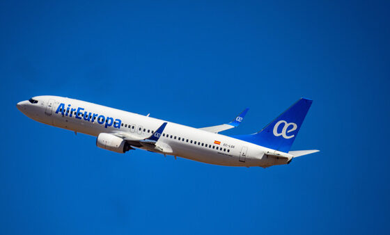 Air Europa passenger jet in mid-flight against a clear blue sky, tail fin visible with logo
