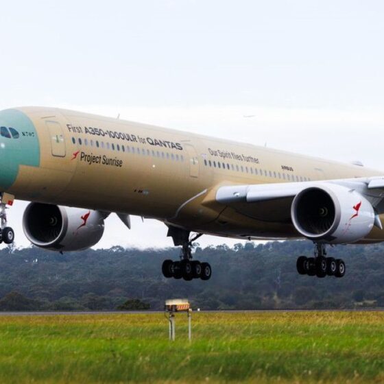Qantas A350-1000 aircraft taking off, wheels down, during climb from a runway.
