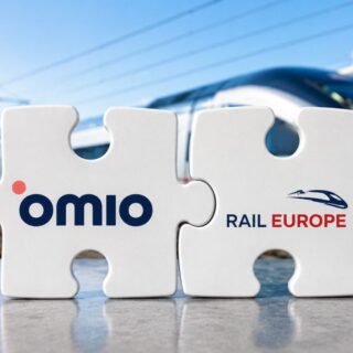 Two interlocking puzzle pieces displaying the Omio and Rail Europe logos, with a high-speed train in the background.