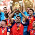 Spain national team players celebrate after lifting a gold trophy amid confetti and cheers