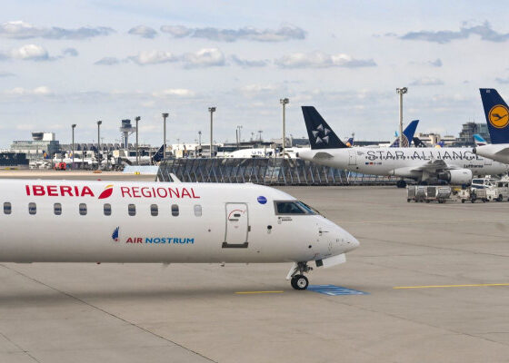 Airline planes on a tarmac at an airport, Iberia Regional and Air Nostrum in the foreground with other jets parked in the background.