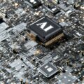 Close-up of a computer motherboard showing a central processor chip with surrounding circuitry and components
