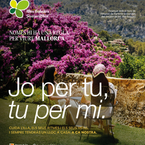 Poster promoting sustainable travel in Mallorca, showing two women seated outdoors with bright pink bougainvillea and mountain backdrop, plus campaign logo and Catalan text.